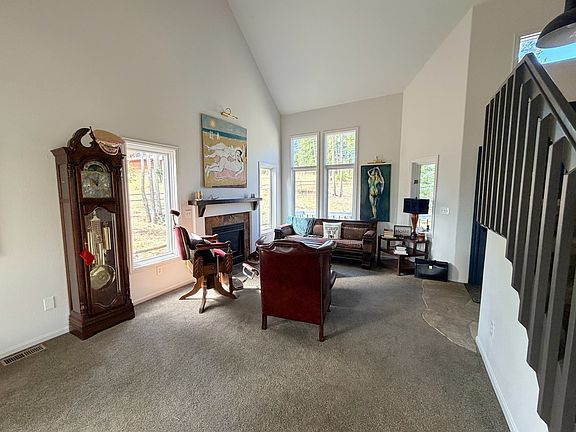 Big, beautiful windows that have been slightly tinted to protect furniture from sun damage. 20' ceilings, gas fireplace just flip a switch to turn on fireplace!