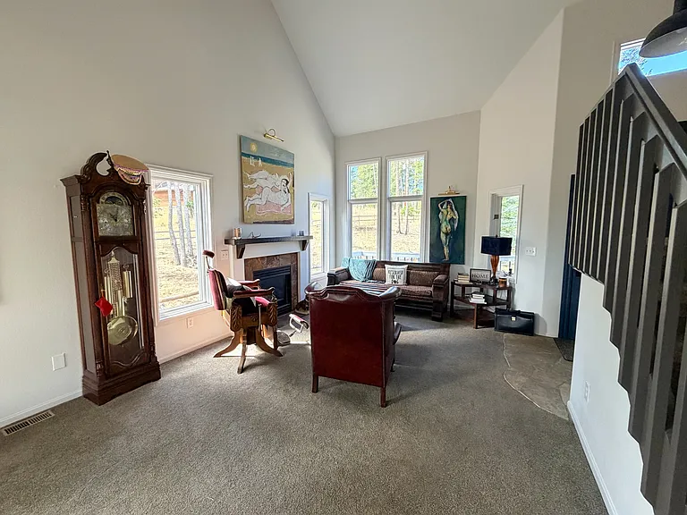 Big, beautiful windows that have been slightly tinted to protect furniture from sun damage. 20' ceilings, gas fireplace just flip a switch to turn on fireplace!