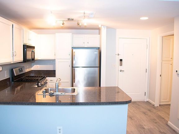Open concept living space, with very spacious living room/kitchen. Also pictured are the two linen cabinets in the bathroom.