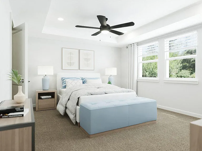 Primary Bedroom with king size bed and large window letting in nice natural light.