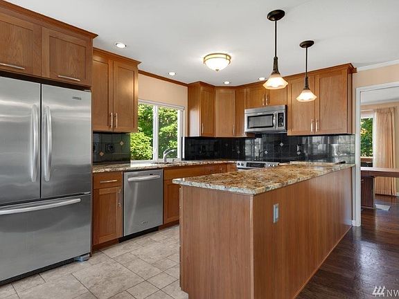 The updated kitchen is sure to please! You'll love the stainless steel KitchenAid appliances including a glass top stove, quiet close drawers, under-cabinet task lighting, upgraded cabinet features and a separate pantry.