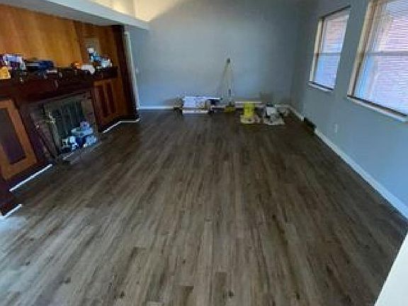 New flooring through out the home as well as drywall and fresh Sherwin Williams "Lazy Gray" paint. (Main Living room pictured after flooring install)