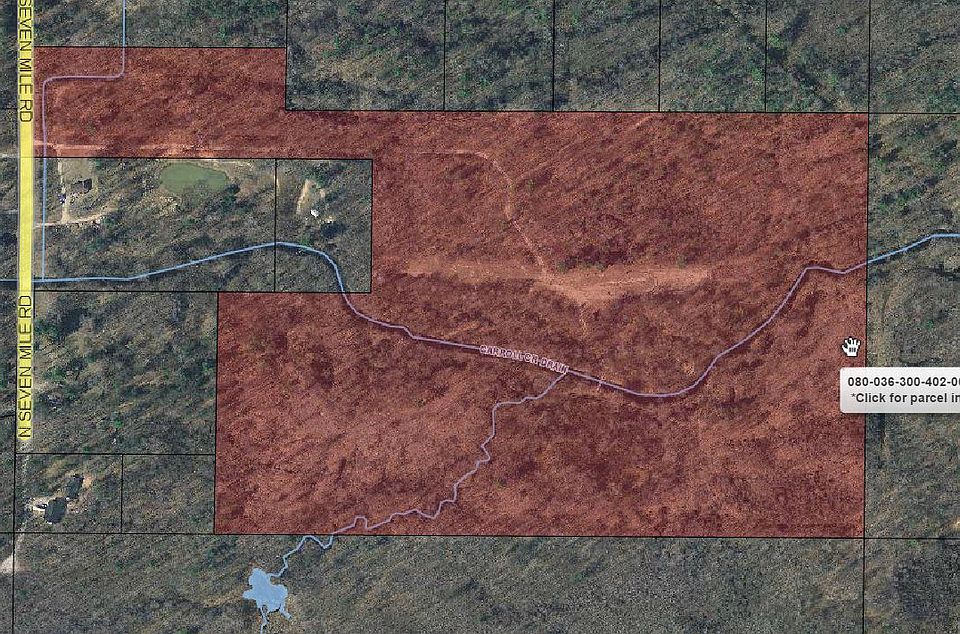 Seventh Heaven!  62.36 serene acres await you. Build your dream home, use for hunting, or both! The driveway and home site have been cleared and are ready to finish. The majority of the property is on dry sand ridges. City water is available at road and the water assessment has been paid. Over 1800 feet of the main branch of Carrol Creek winds through the property, drawing in abundant wildlife and fish. Groomed trails run throughout the property and bridges cross the creek in two locations. The property includes a wonderful hunting cabin with a sleeping loft and wood burning stove. Several deer blinds on the property abut an area planted with rye. Property corners have been staked.