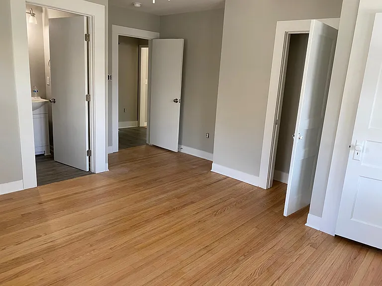 Gorgeous refinished 1940's solid wood flooring in this gorgeous bedroom. Two closets, private bath added in the remodel with tile surround tub and luxury vinyl plank easy care bathroom flooring.