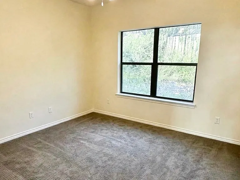 Third upstairs bedroom, carpet flooring, big window overlooking greenery from private backyard, lots of natural light
