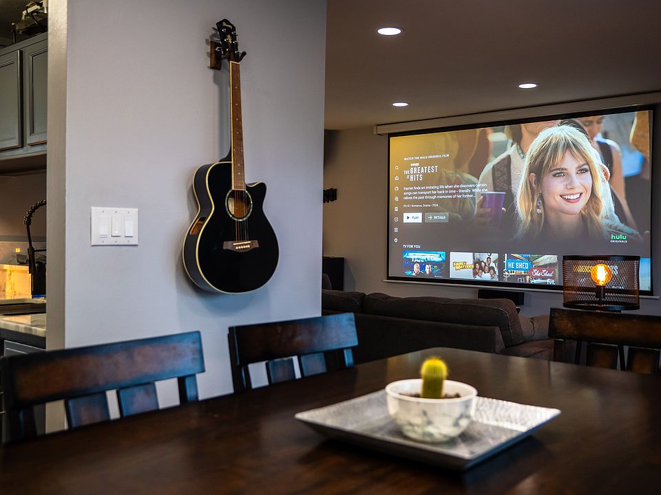 Dining room table with view of living room and projector screen