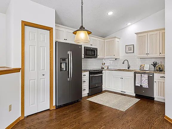 Kitchen with stainless steel and custom built cabinetry.