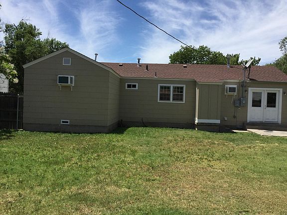 Back of house with small storage room