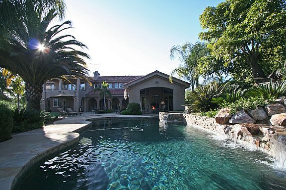 Salt pool with waterfall and spa heated by solar or propane
