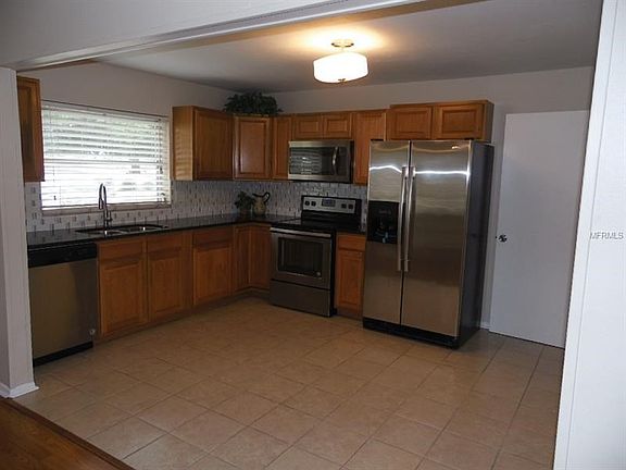 Open kitchen with nice granite counter top and new stainless steel appliances