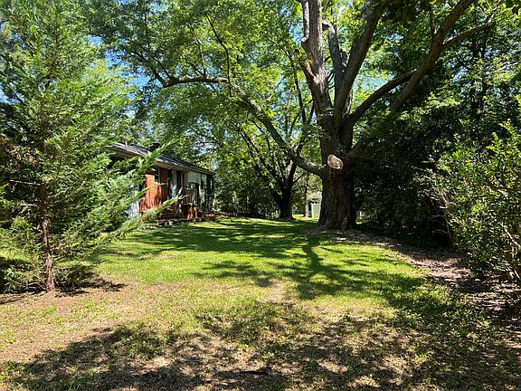 Half-acre yard with poured-concrete deck _ great for outdoor dining, play, or weekend barbecues.