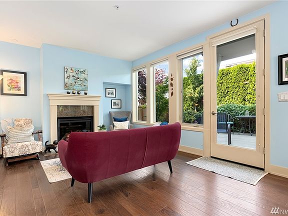 Living room with natural gas fireplace and glass door to your garden