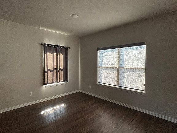 Dining area off the kitchen bar. Shades and curtains stay.