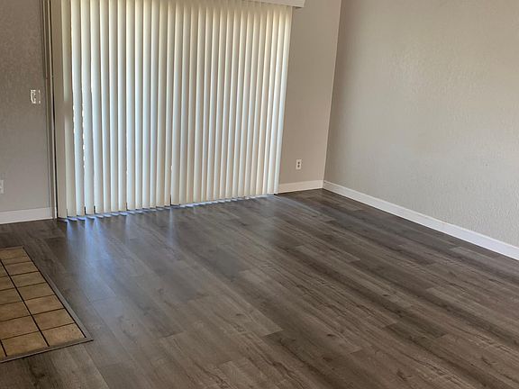 large living area with wood burning fireplace and balcony