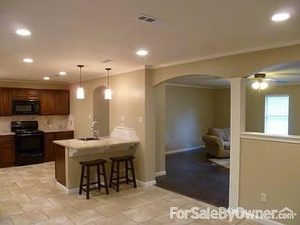 Dining and Kitchen view : Spacious Dining Area. Open floor plan. LED lighting.