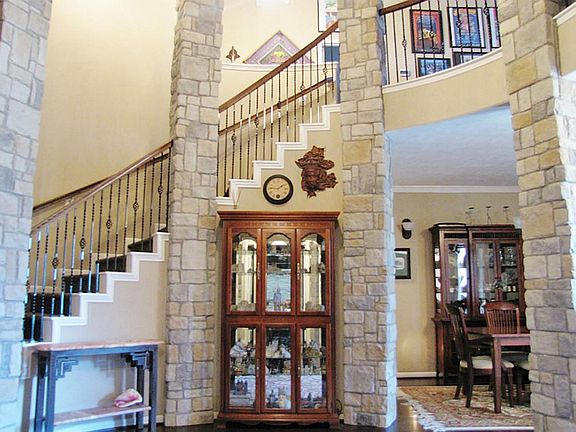 GRAND STAIRCASE LEADING UP TO THE GAME & MEDIA AREA AND 3 MORE BEDROOMS