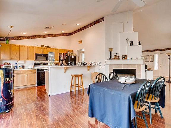 FAMILY DINING AREA WITH 2 WAY FIREPLACE INTO LIVING ROOM
