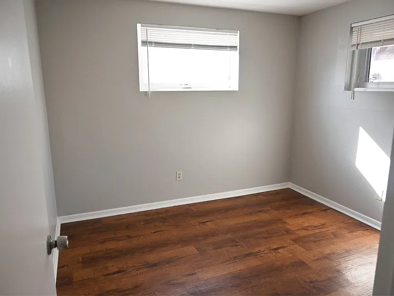 Bedroom with grey walls at Benson Crest Apartments.