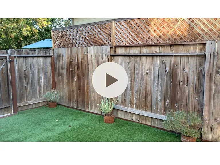 Private backyard with artificial grass turf and patio area to to keep sofa or dinning table