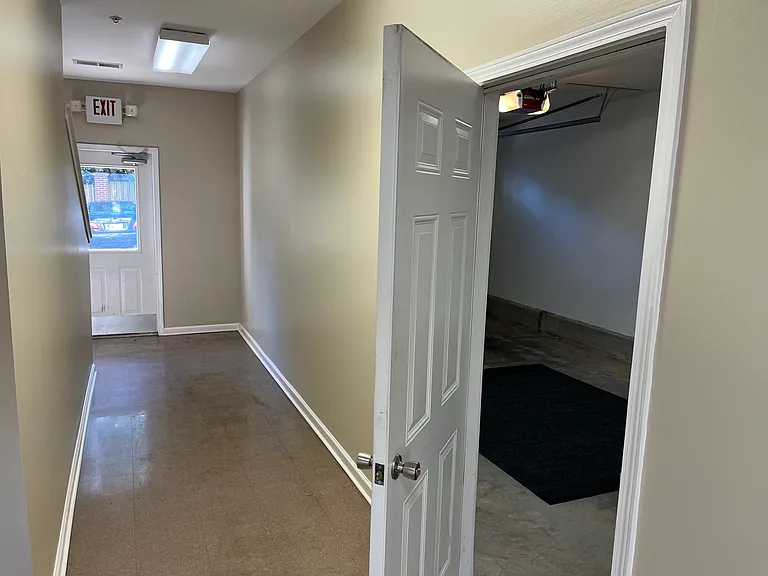 Garage Entry Door on first floor of locked building hallway