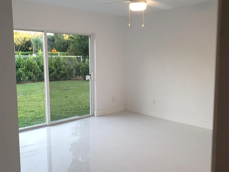 Master bedroom with sliding glass doors out to the private backyard.
