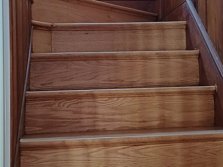 Stairs to two bedrooms, full bath and upstairs storage space.
