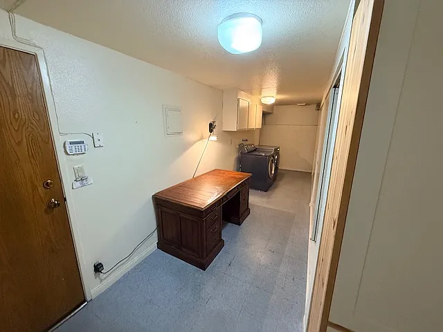 Basement leads to two car garage features a washer and drier