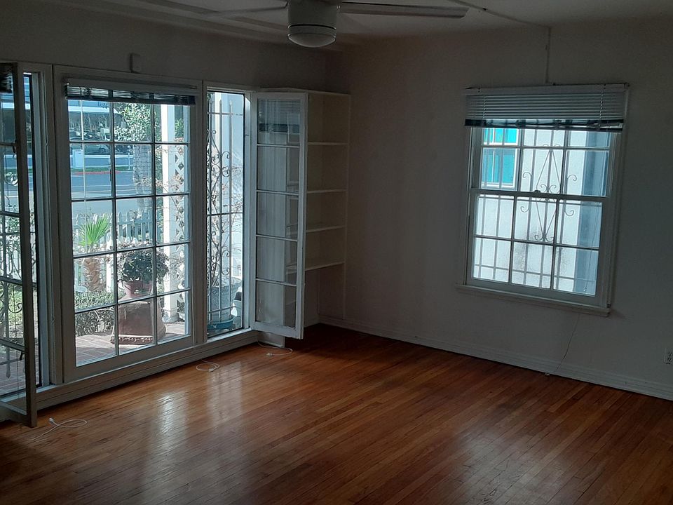 LIVING ROOM View with French Doors opening to Red Brick Patio in Front.
