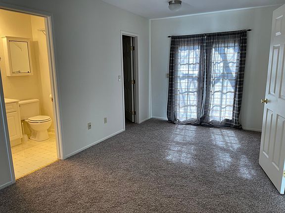 Master bedroom with tiny deck into private rear yard