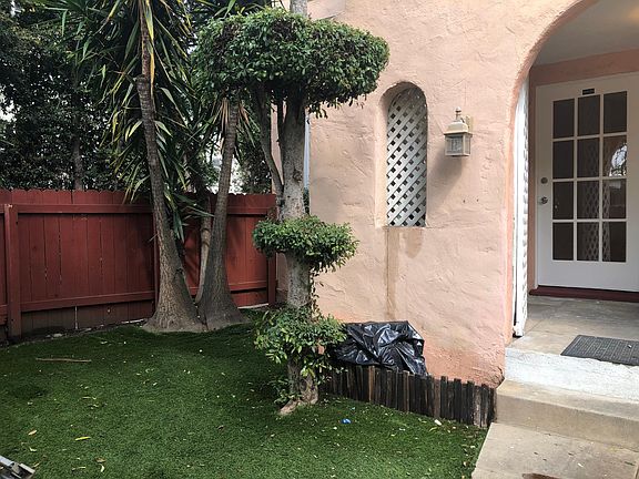 with private front yard ideal for summer bbqs surrounded by green trees and plants.