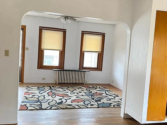 Standing in the dining room and looking back at the living room and front door on left