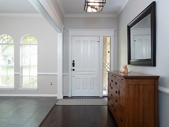 Bright entry has wood floors and plenty of room for a hall table.