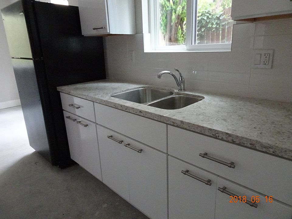 Double sink quartz stone counters white tile back splash nat