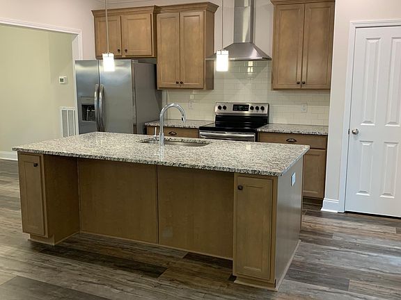 3 barstools would fit nicely around this island. Pantry is inside the door on the right.