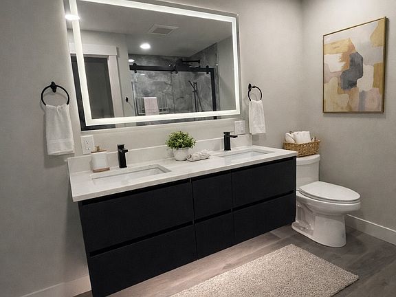 Dual sinks, walk in shower and storage in bathroom