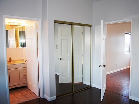 Bedroom, mirrored closet doors, and bathroom