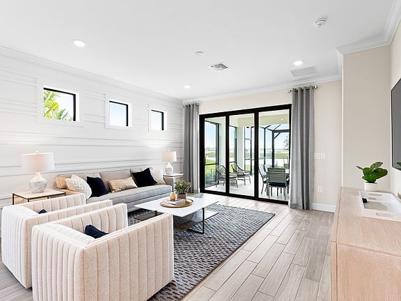 Model Representation Bright gathering room with sliding glass door to lanai