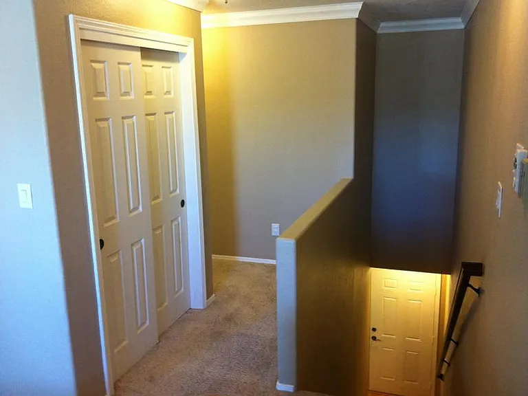 Upstairs landing from entry with guest closet on the way to bedrooms and baths.
