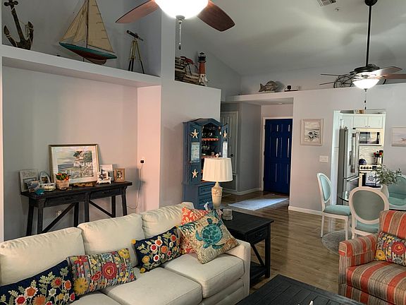 Living room with pot shelve lighting, dual fans with lights.