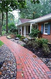 Brick paver walk bordered by river rock accents