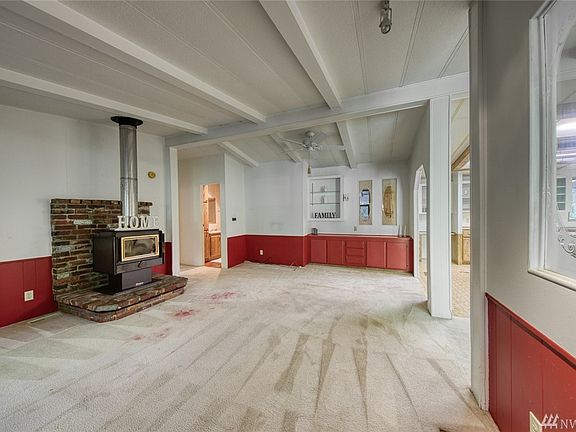 The wood stove keeps the home toasty.  Notice the built-in cabinets.  