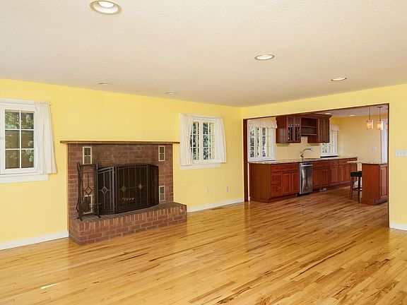 Enter into the living room with wood burning fireplace.