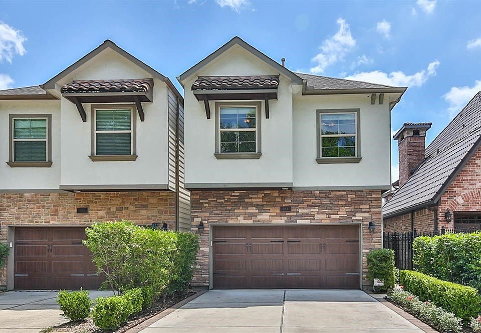 Stunning stucco and stone two story home with first floor main living perfectly situated in Rice Military.  Wide driveway provides ample guest parking.  Access to the front door provided through the private wrought iron gate.