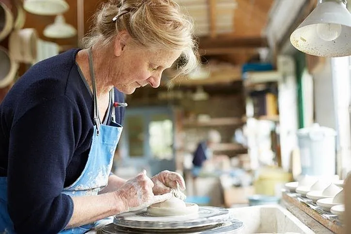 Lady Throwing Clay