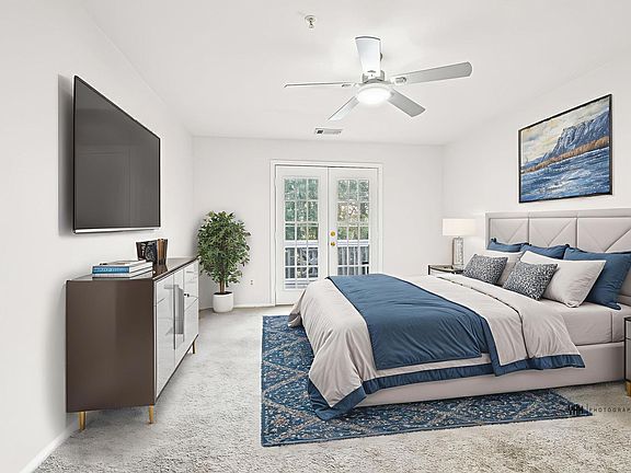 staged master bedroom - French doors lead out to balcony