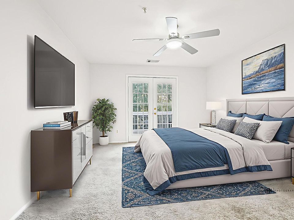 staged master bedroom - French doors lead out to balcony