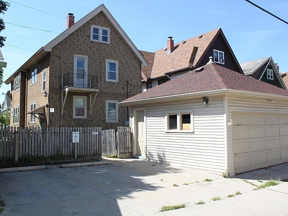 Rear, with fenced in back yard, 2-car garage and two additional parking spaces.