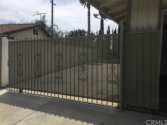 Sliding gate to large concrete pad in backyard