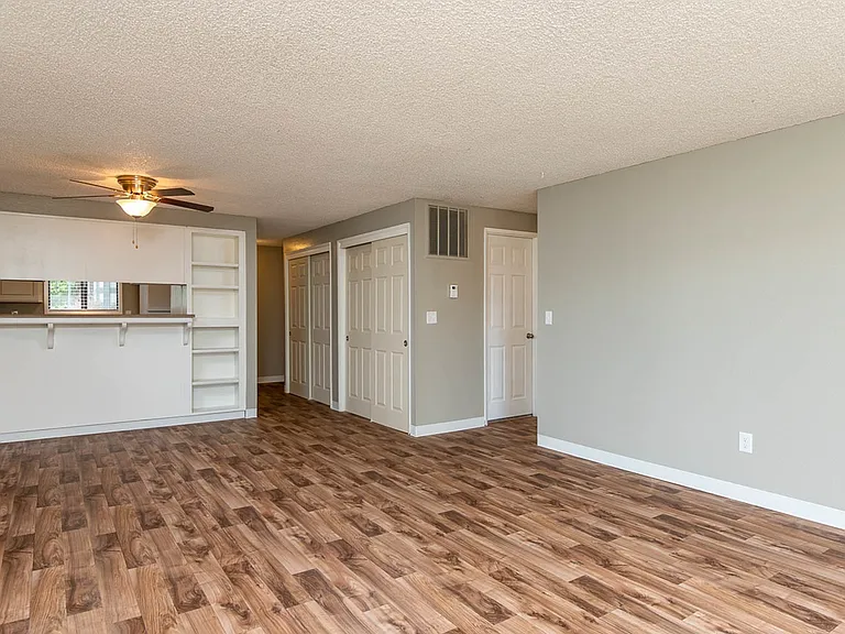 Living Room with Wood-Inspired Vinyl Flooring and Built-In Shelving