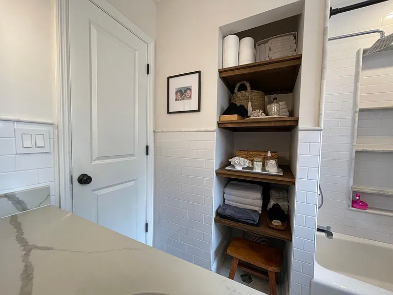 Deep exposed shelving in the main bathroom.